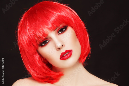 Fototapeta Naklejka Na Ścianę i Meble -  Portrait of young beautiful sexy girl with stylish make-up and fancy bob style red wig