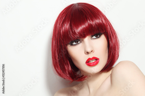 Portrait of young beautiful sexy red-haired girl with bob haircut and stylish make-up looking upwards