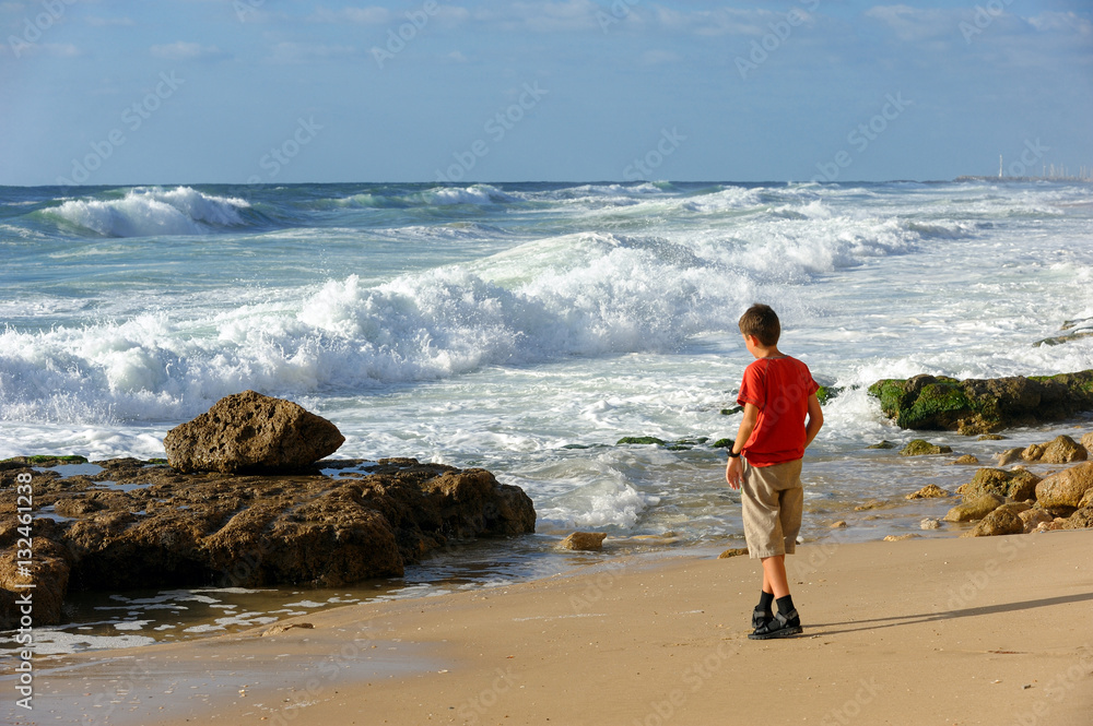 Boy on the shore of the Mediterranean Sea in Israel