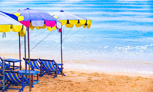 Beach chairs with colorful umbrella
