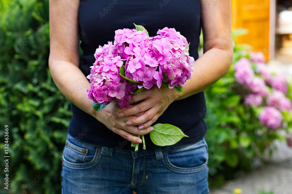 woman holding a bouquet of hydrangeas in her hands, woman holding a bouquet of hydrangeas in her hands,