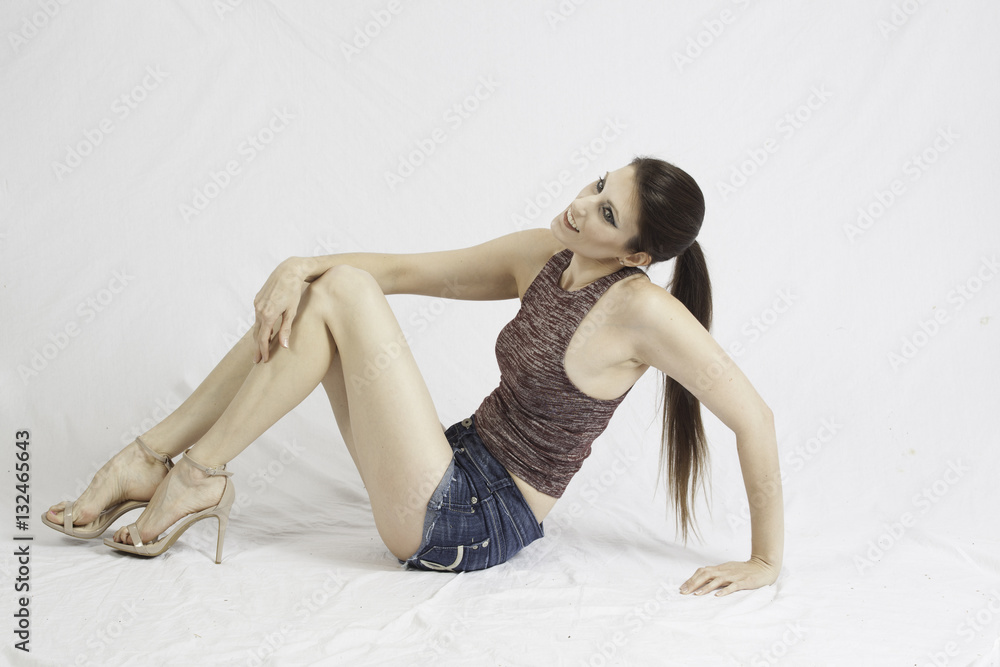 Pleased woman sitting on floor