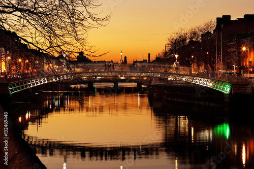 Photography Ha'penny Bridge and the north banks of the river Liffey in Dublin City Centre at night