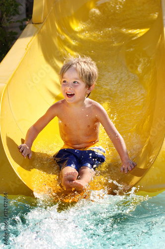 Foto Boy on a water slide