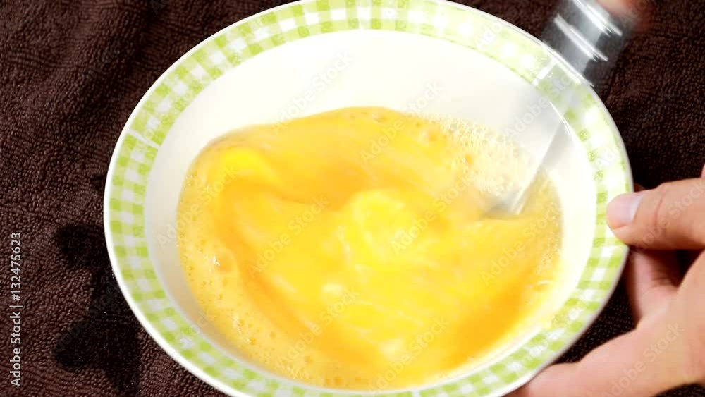 whipping egg in bowl whipping egg in bowl