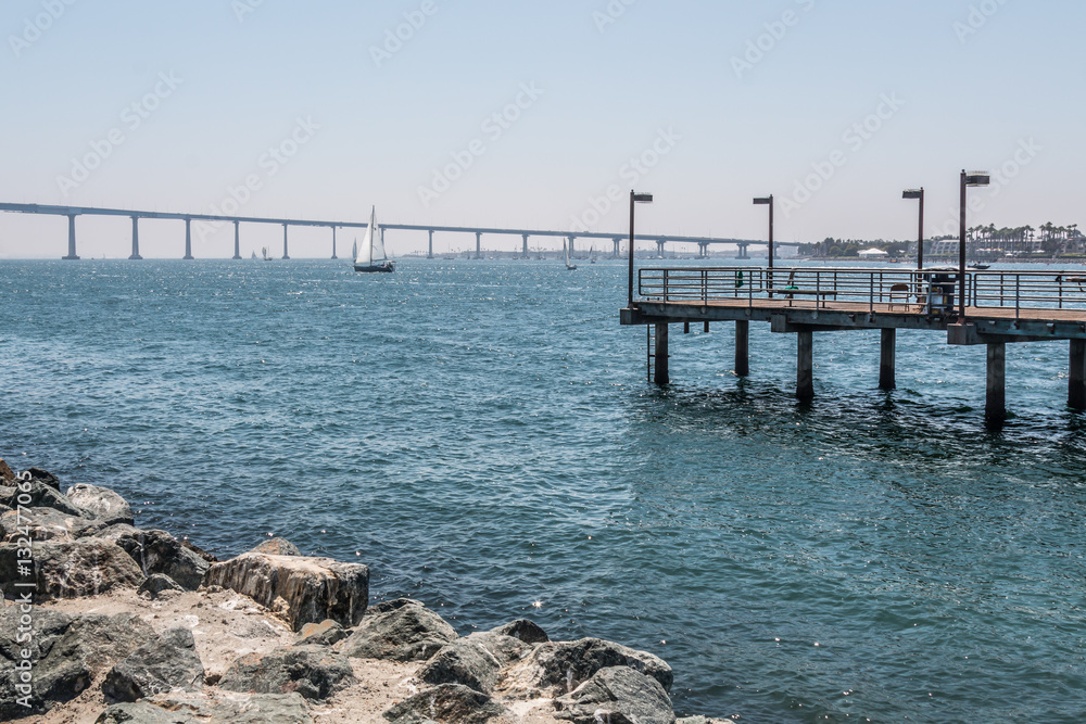 Fishing pier at Embarcadero Park South in San Diego, California, with the Coronado Bridge in the background.