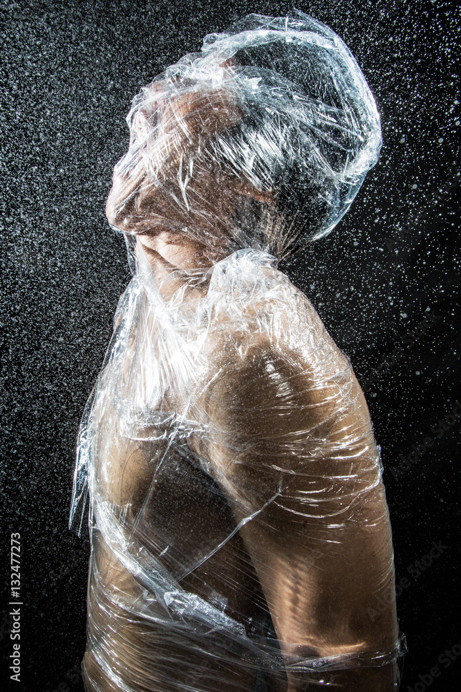 person trapped in plastic sheets