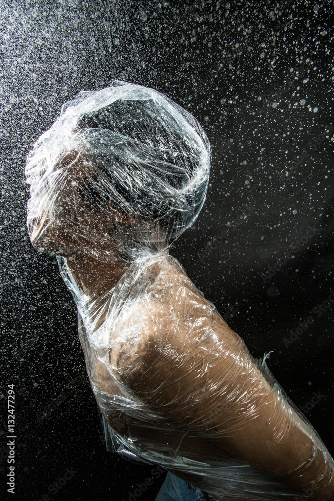 person trapped in plastic sheets