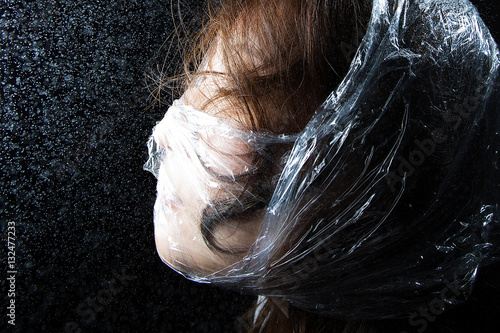 person trapped in plastic sheets