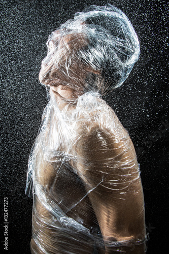 Obraz na płótnie person trapped in plastic sheets w salonie