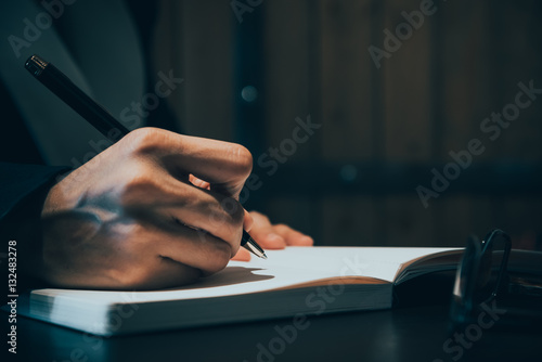 Wallpaper Mural Close up of business people hand in suit writing on notebook or Torontodigital.ca
