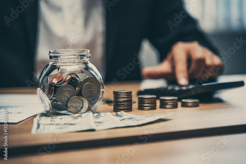 фотографія Close up of business man working with coins and money on the tab