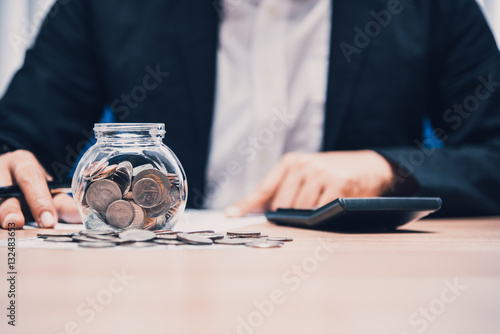 Wallpaper Mural Close up of business man working with coins and money on the tab Torontodigital.ca