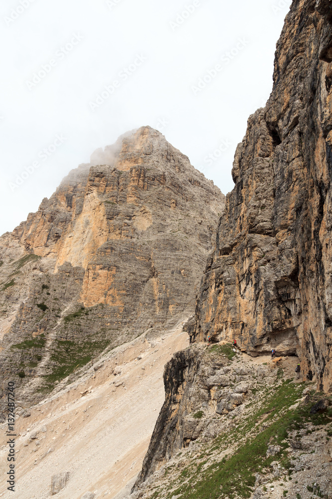 People climbing the Via Ferrata Severino Casara in Sexten Dolomites with mountain panorama, South Tyrol, Italy