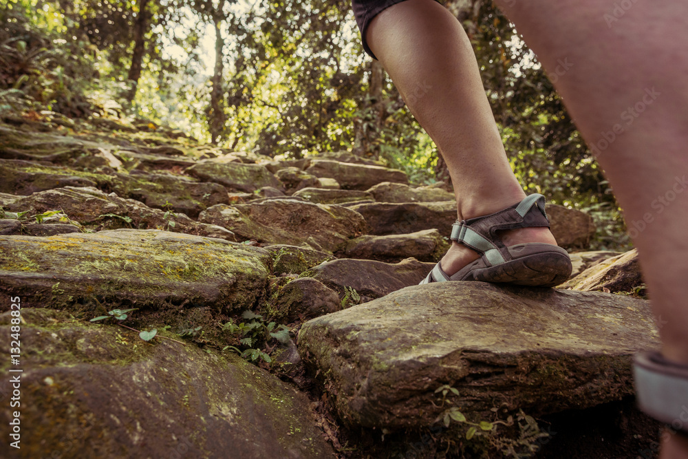 Closeup of female legs wearing sandals ascending forest staircase. Closeup of female legs wearing sandals ascending forest staircase.