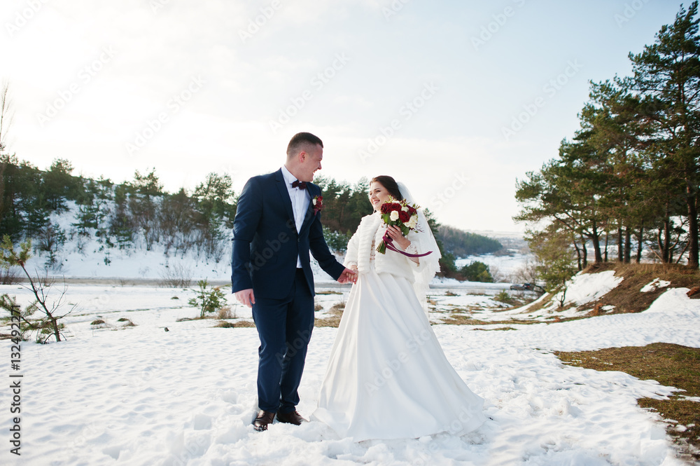 Amazing young wedding couple in love at winter day