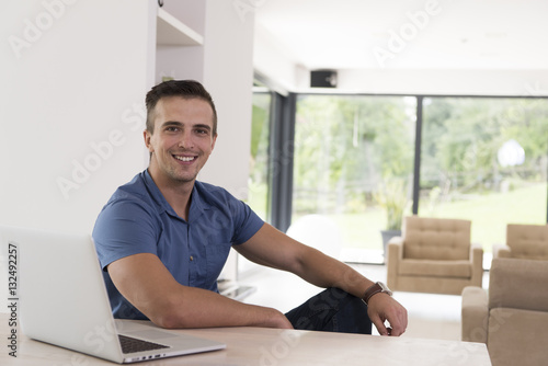 Young man with laptop at home