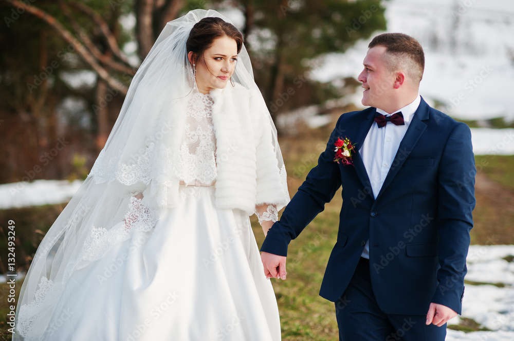 Amazing young wedding couple in love at winter day