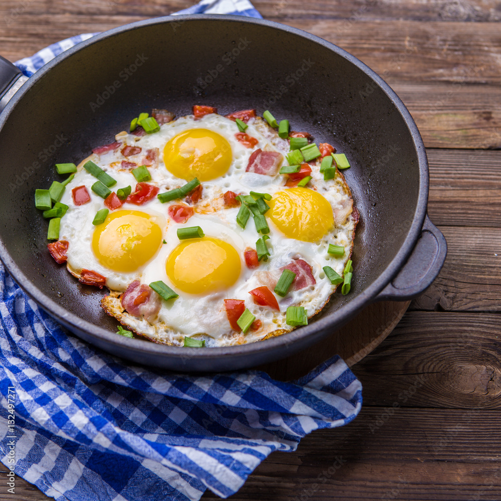 Fred eggs in pan with tomatoes and green fresh onion. Fred eggs in pan with tomatoes and green fresh onion.