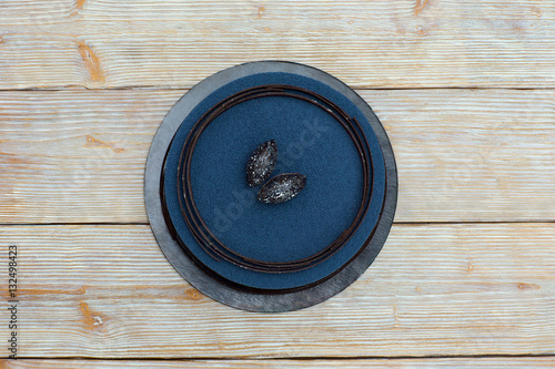 Blue mousse cake on wooden background flat lay photo