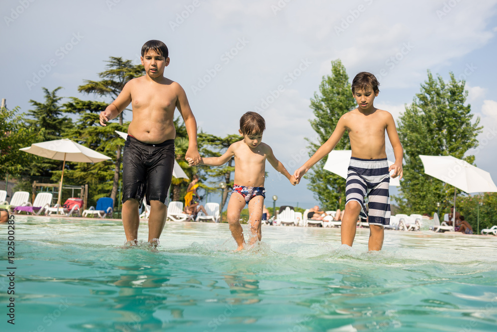 Happy time for kids of fun and enjoyment on summer swimming pool Happy time for kids of fun and enjoyment on summer swimming pool