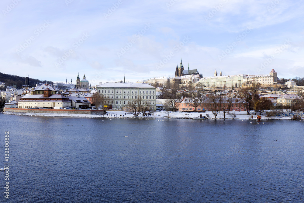 Snowy freeze Prague Lesser Town with gothic Castle above River Vltava, Czech republic