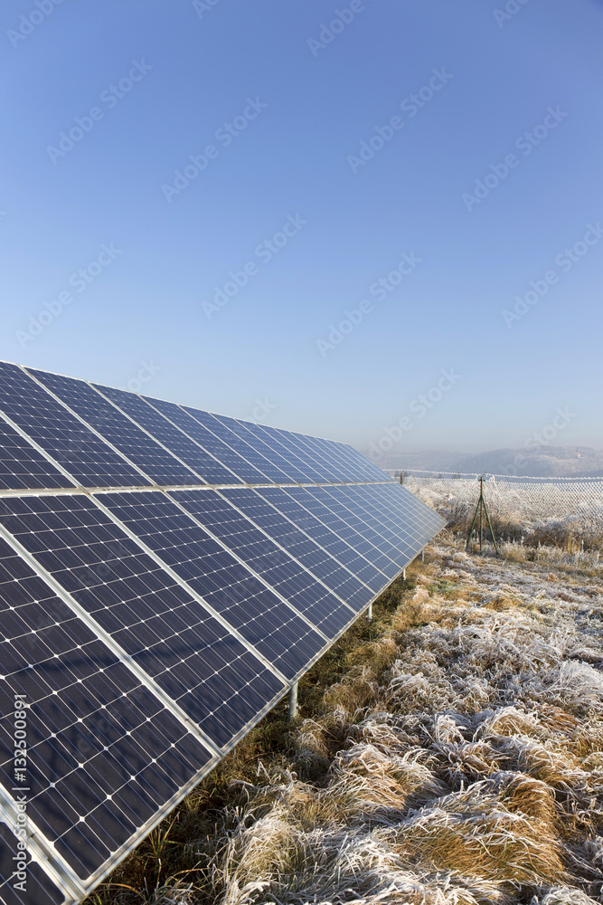 Solar Power Station in the snowy freeze winter Nature