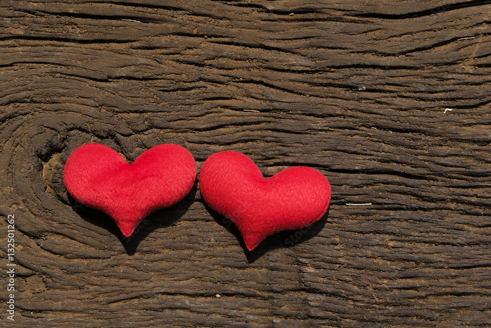 Two red hearts on old shabby wooden background with sunlight Two red hearts on old shabby wooden background with sunlight