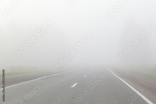 mist over asphalt road at dawn