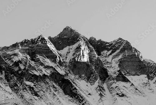 The first rays of the morning sun on the fourth in the world at the height of mount Lhotse (8516 m), view from the Chhukhung Ri - Everest region, Nepal (black and white) photo