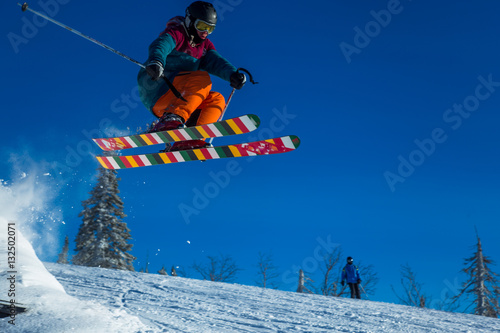 Skier on off-piste slope in forest riding very fast. Ski backcountry resort Sheregesh.