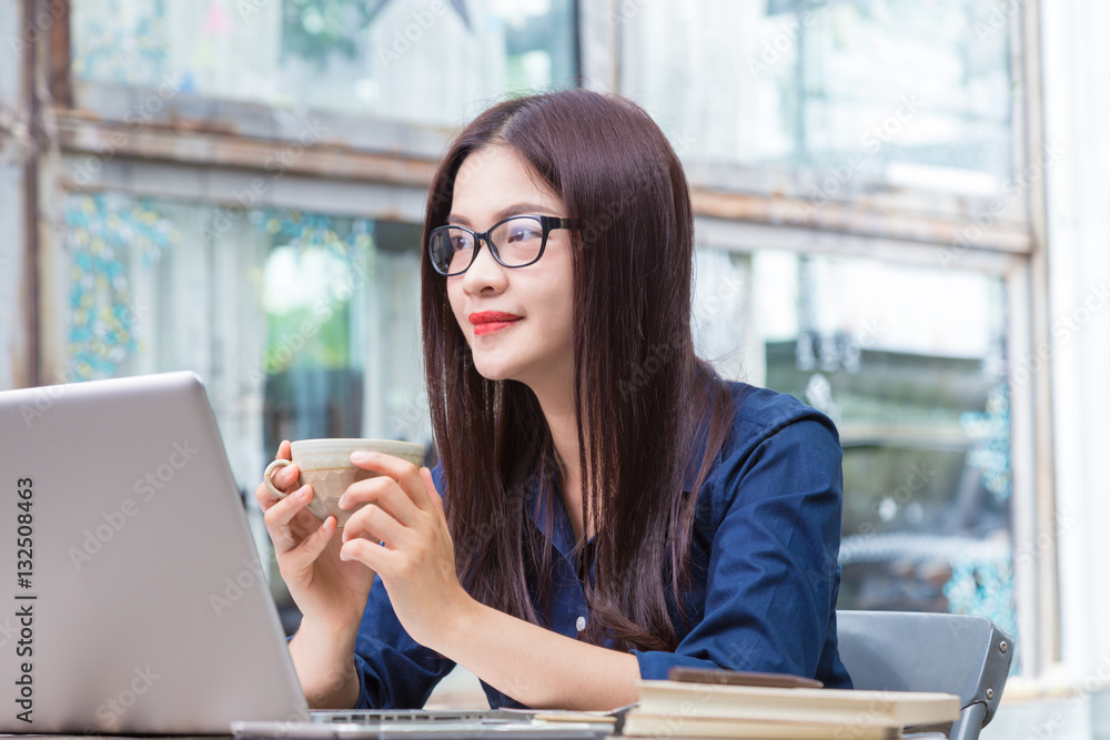 young asian woman holding cup of coffee and taking a break from young asian woman holding cup of coffee and taking a break from