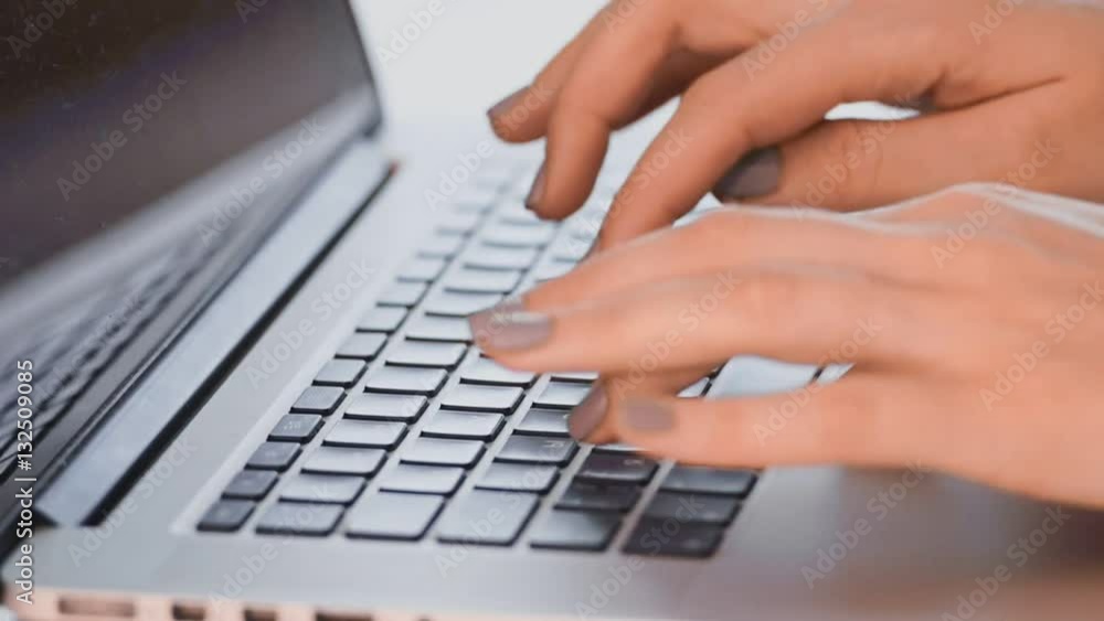 Close-up of a young woman working on a laptop. Slow motion Close-up of a young woman working on a laptop. Slow motion