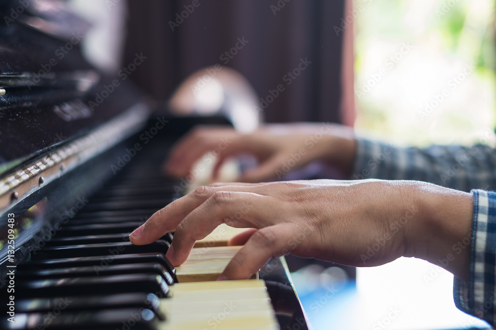 Fototapeta premium Hands musician playing the piano closeup