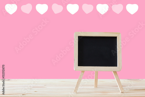 mini blackboard on wood table / mini blackboard stand with pink background and heart pattern