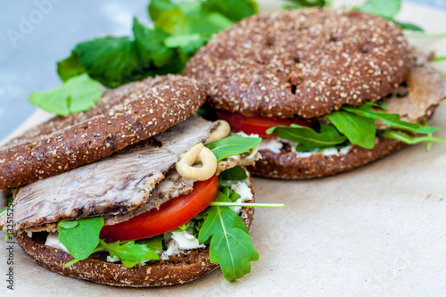 Healthy sandwich with rye bun, beef and vegetables.  Healthy homemade food