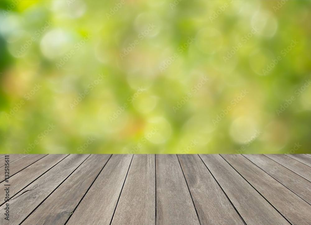 Wooden top table and green blurred bokeh background Wooden top table and green blurred bokeh background