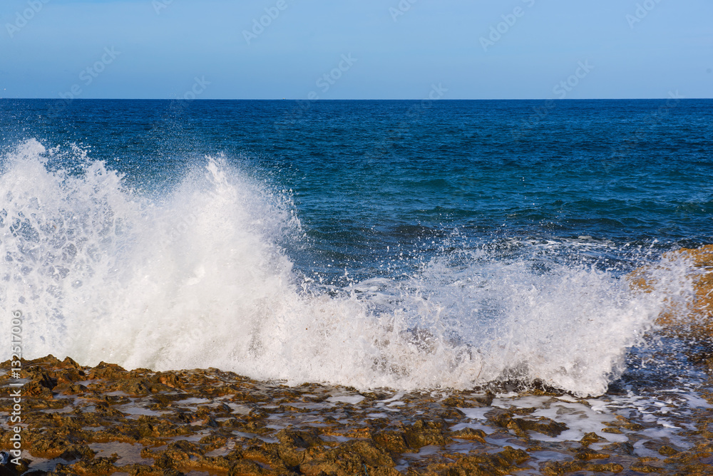 Sea wave splashing on rocks, natural holiday vintage hipster seasonal background