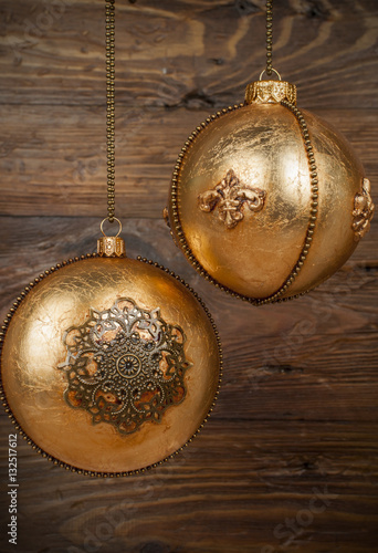 handmade golden chrostmas ball on wooden background photo