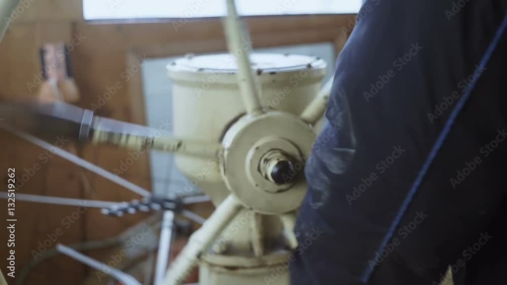 Captain turns steering wheel of ship, sharp turn hd StockVideo Adobe Stock