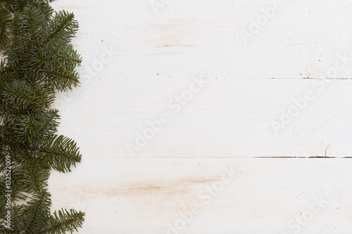 Top view with copy space on Christmas or New Year background: fur-tree on white wooden table. Holidays season.