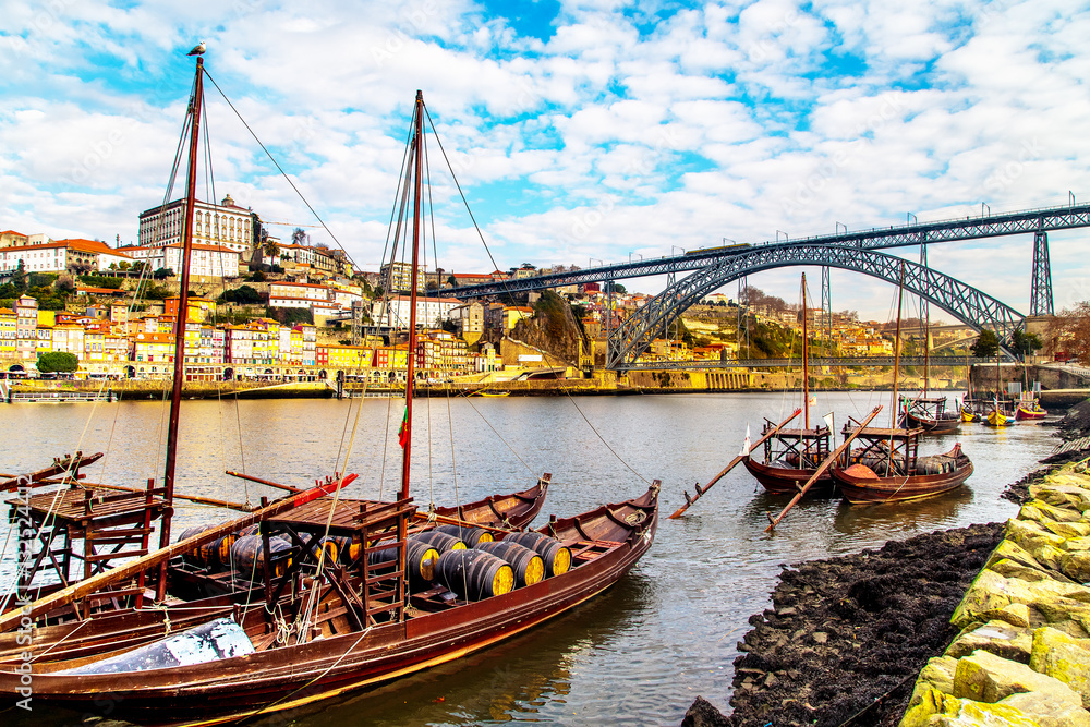 A view of boats transporting Porto wine with Porto in the background, Portugal A view of boats transporting Porto wine with Porto in the background, Portugal