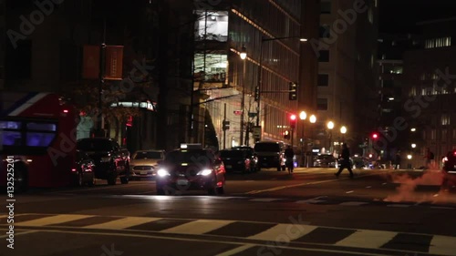 Street scene in Washington DC at night. Traffic and Pedestrians.