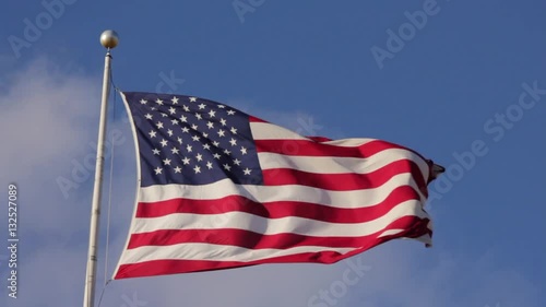 American flag blowing violently in the wind at the National Harbor in Washington