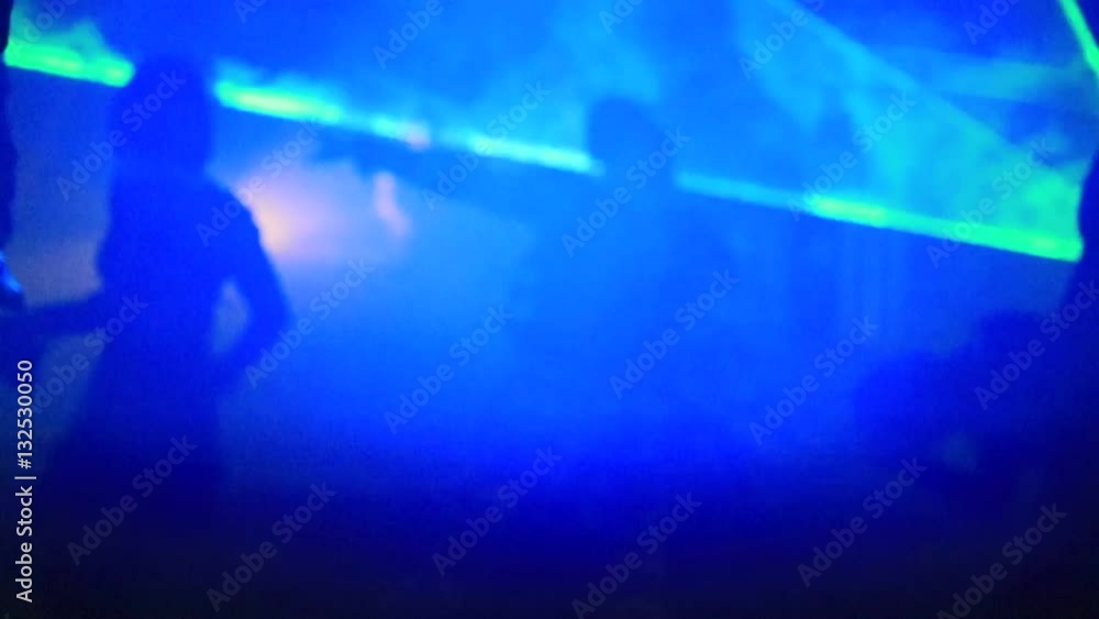 Slow motion of a cyber dancer boy in black and fluorescent green dress, daincing in the dark fog with laser lights. Slow motion of a cyber dancer boy in black and fluorescent green dress, daincing in the dark fog with laser lights.