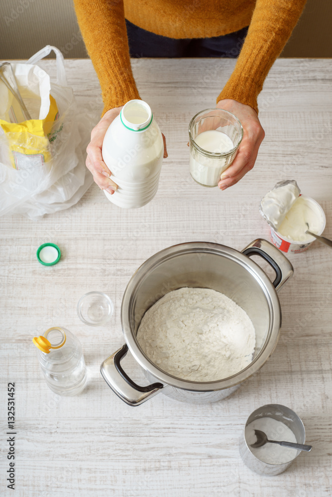 Ingredients for cooking dough pizza on the white table Ingredients for cooking dough pizza on the white table