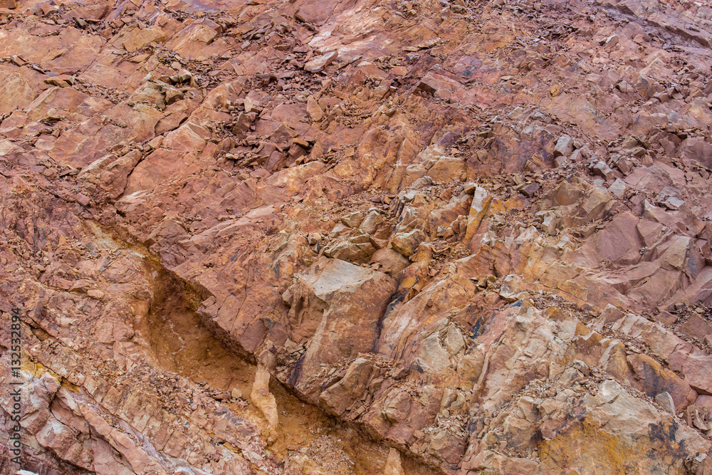 Fototapeta premium Irregular pattern orange stone wall