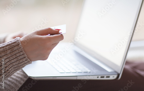 Woman hands holding credit card and using laptop. On line shopping