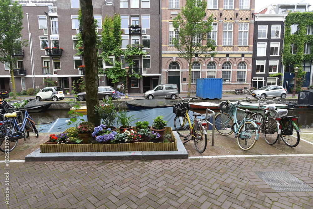Amsterdam canal with flowers and bicycles
