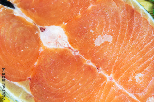 Close up of fresh salmon slices on wood background.